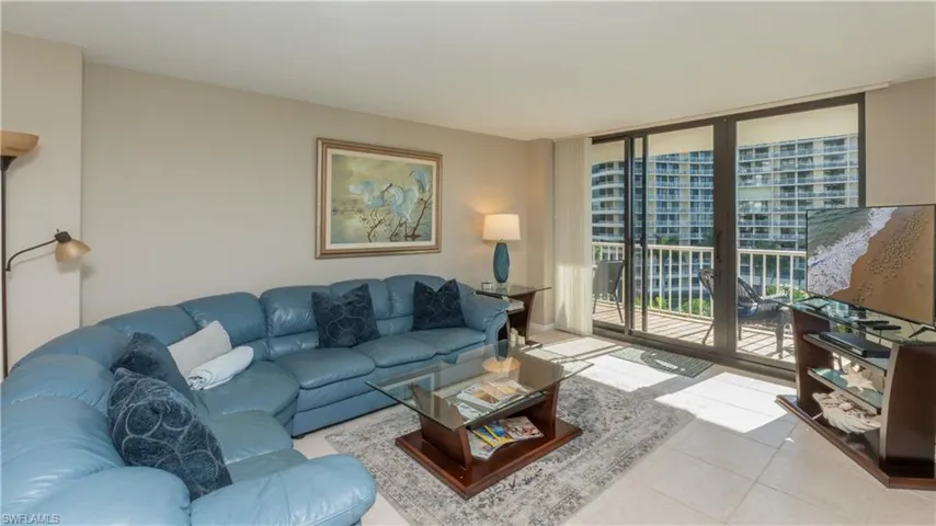 Living area featuring expansive windows and tile patterned flooring