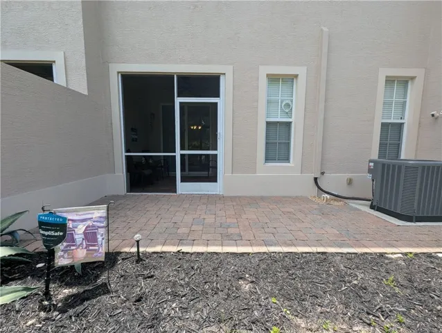 Back of house with central air condition unit, a patio, and stucco siding