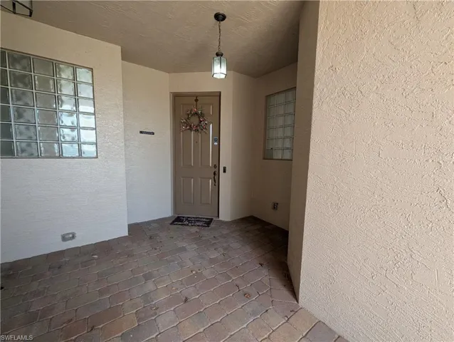 Entrance to property with stucco siding