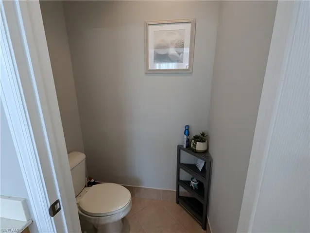Bathroom featuring toilet and tile patterned flooring