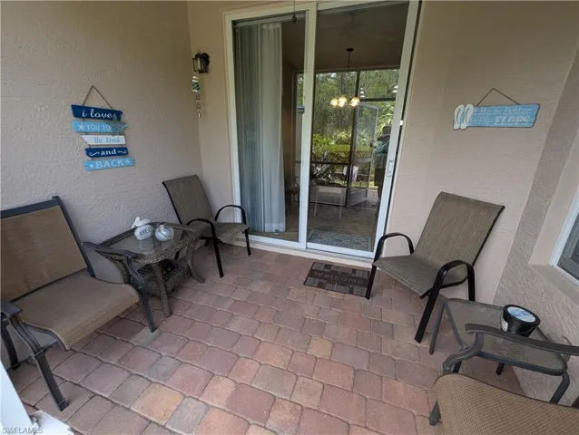 Entrance to property with stucco siding