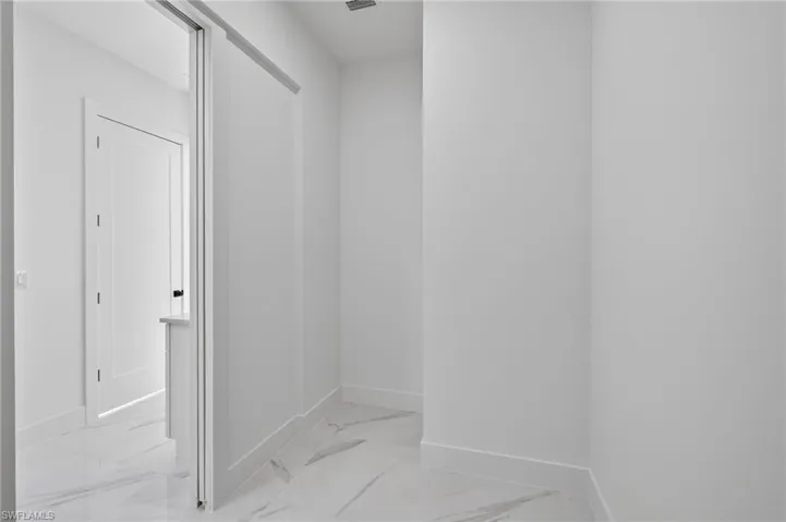 Bathroom with baseboards and light marble finish floors