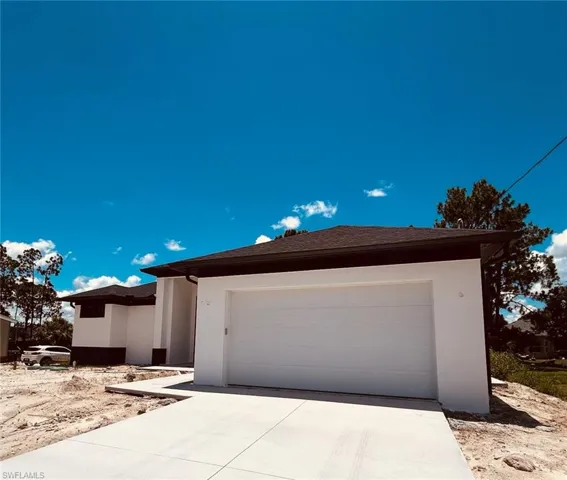 View of front of home with stucco siding and concrete driveway