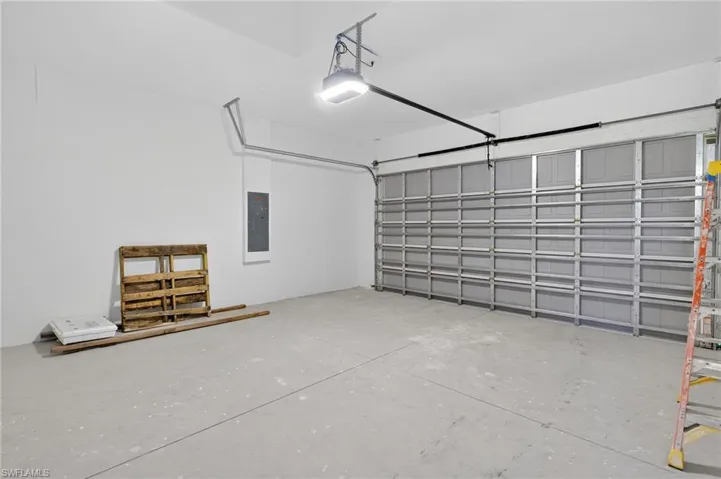 Garage with a garage door opener and electric panel