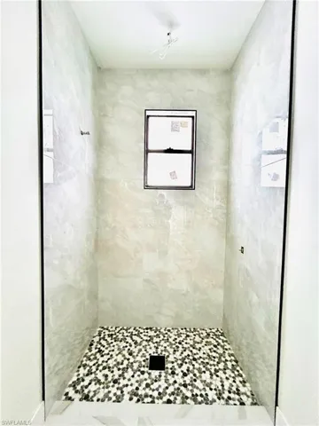 Full bathroom featuring tiled shower