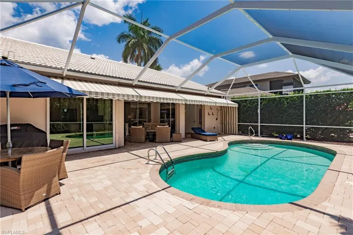 View of pool with a lanai and a patio