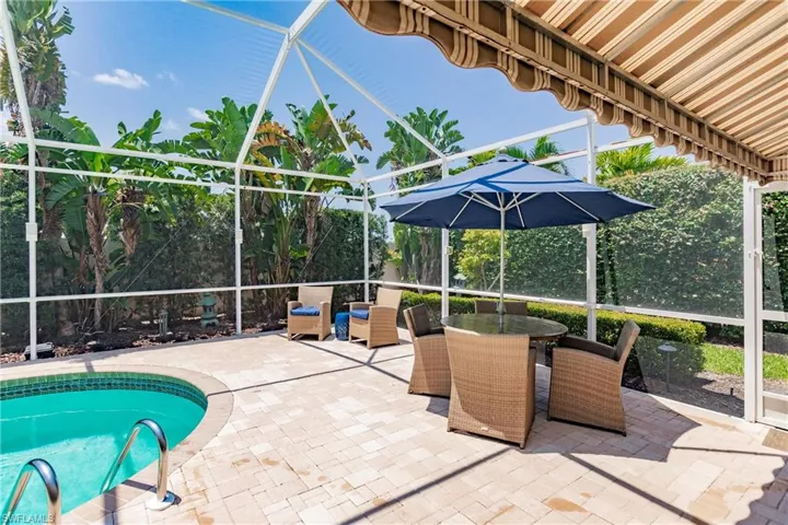 View of pool with a patio area and a lanai