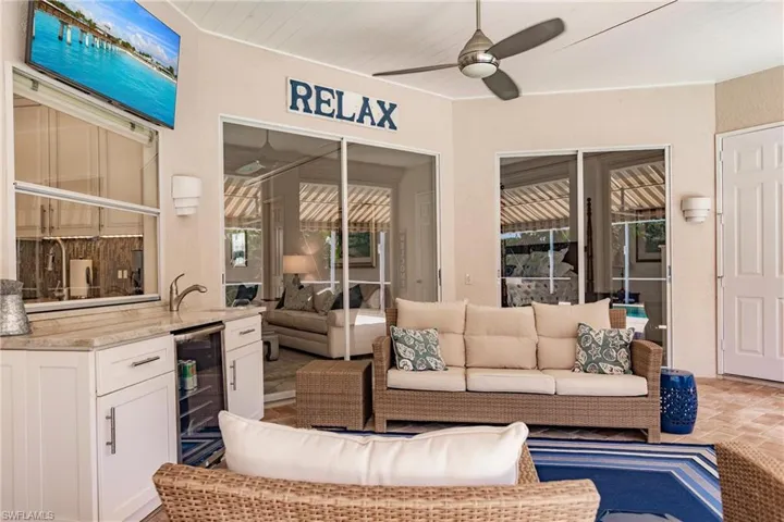 View of patio / terrace featuring ceiling fan, beverage cooler, an outdoor living space, and sink