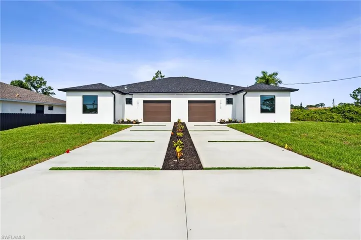 View of front of property with a garage and a front yard