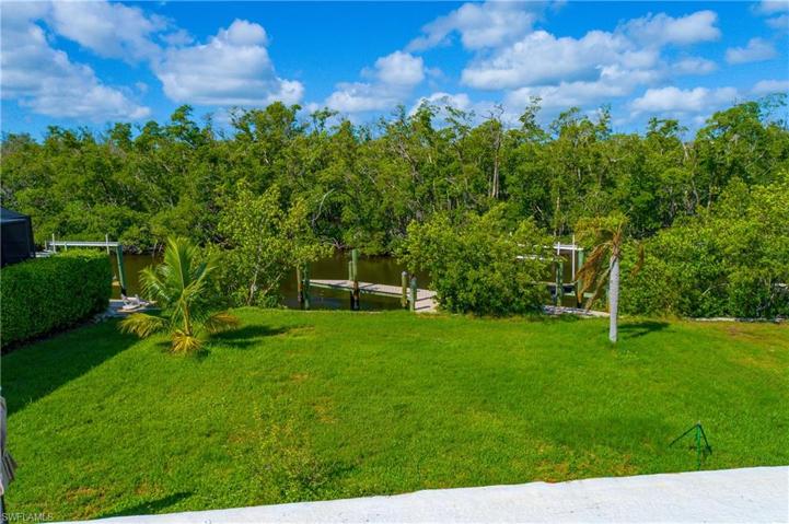 Plenty of room for a pool in this large backyard overlooking wide canal/preserve views.