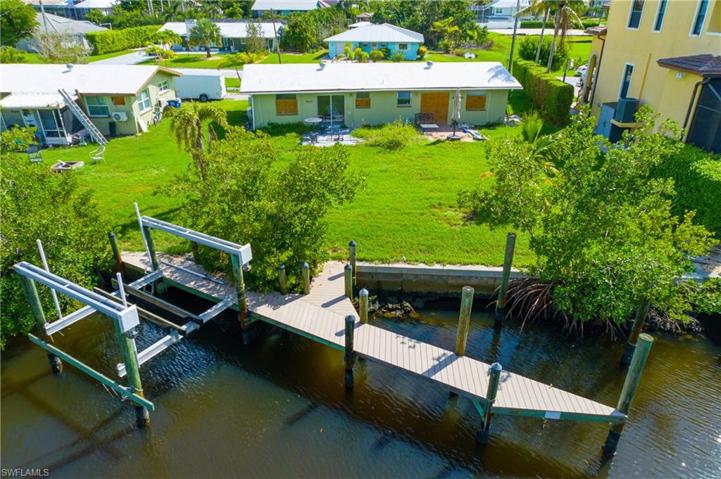 Great opportunity for investors. Renovate this DUPLEX or rebuild your dream home on this FABULOUS WESTERN facing lot in Bonita Springs. Lot includes Boat slip and Boat lift on a WIDE canal! Easy and fast access to the gulf.
