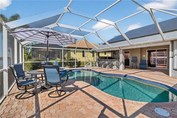 Screened Pool featuring large patio area and outdoor kitchen