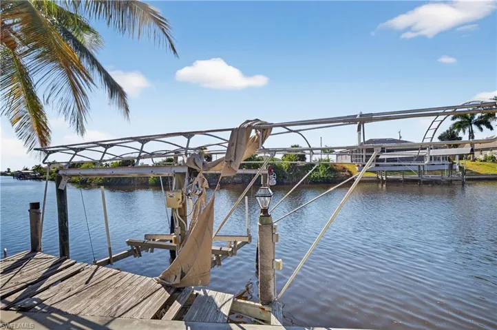 Dock featuring boat lift and canal