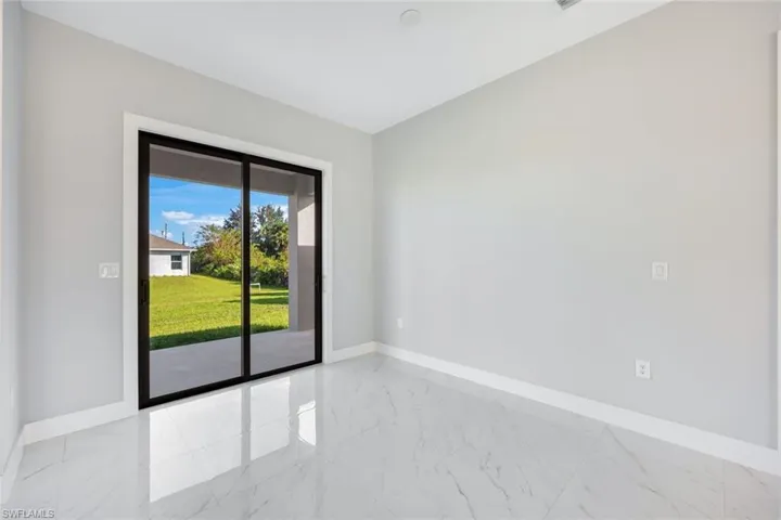 Spare room with light marble finish floors and baseboards