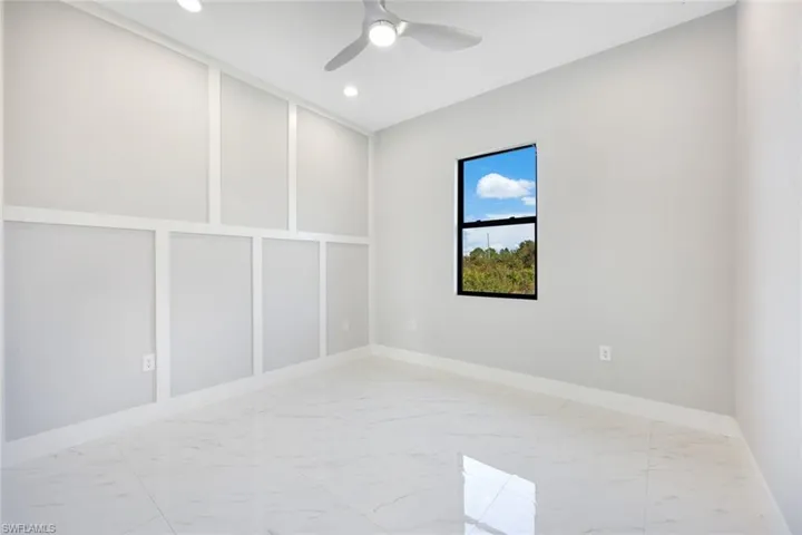 Spare room featuring light marble finish flooring, a ceiling fan, and recessed lighting