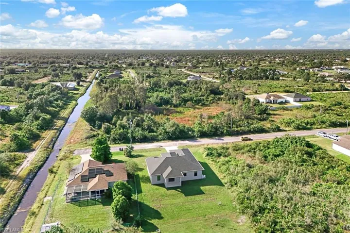Aerial perspective of suburban area featuring a nearby body of water