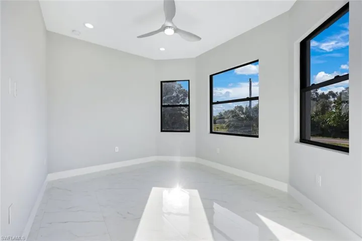 Empty room with light marble finish floors, recessed lighting, and ceiling fan