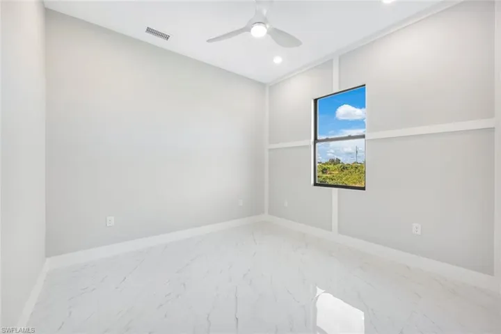 Spare room featuring marble finish floors, recessed lighting, and a ceiling fan