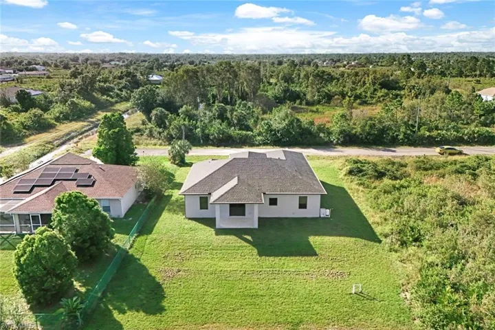 View of subject property featuring a heavily wooded area