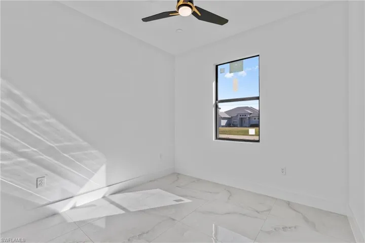 Unfurnished room with baseboards and light marble finish flooring