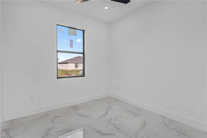 Unfurnished room with light marble finish floors, recessed lighting, and a ceiling fan