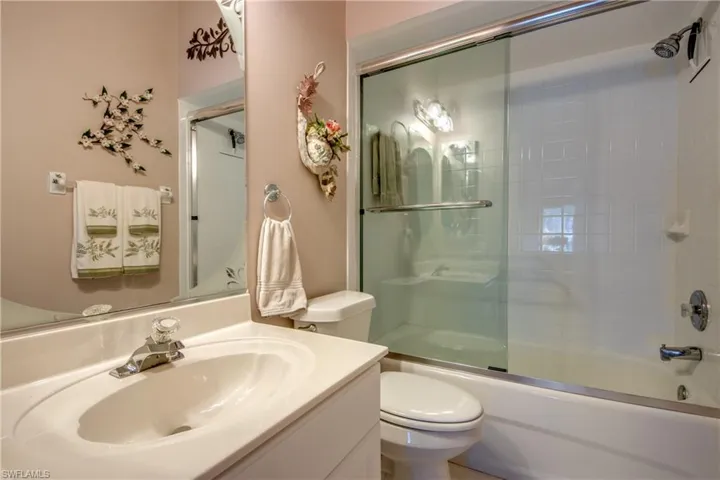 Guest Bath with newer shower enclosure, newer commode and newer re-faced vanity.
