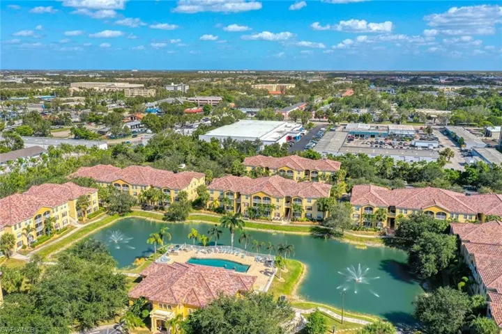 Aerial view toward condo with Amenity center and pool in foreground
