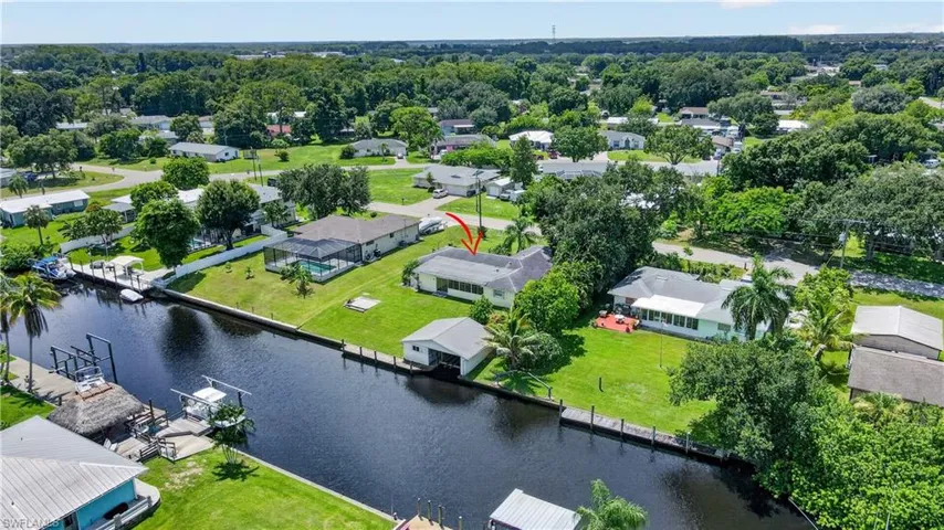 Waterfront property featuring a private boat lift and dock access