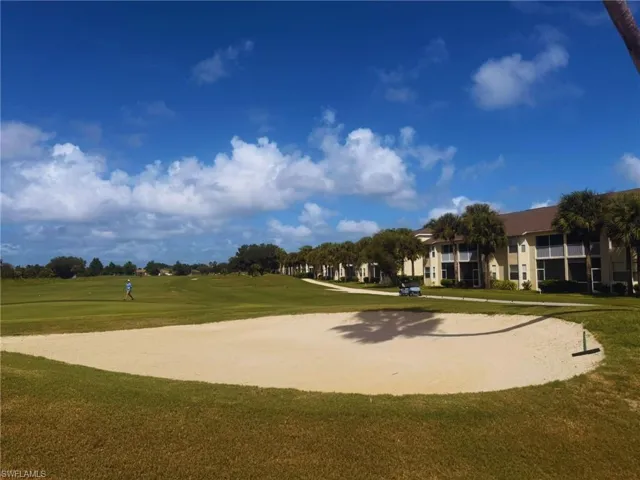 View of home's community featuring golf course view and a lawn