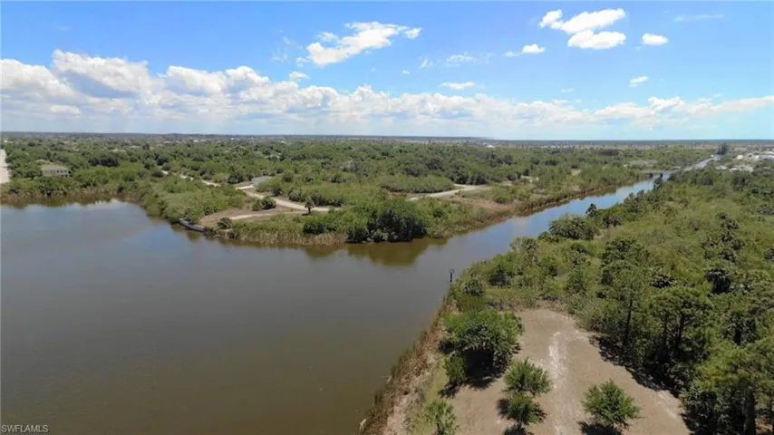 Aerial view of a heavily wooded area and a large body of water