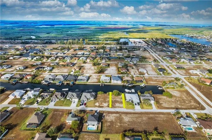 Aerial view of property's location featuring nearby suburban area and a large body of water