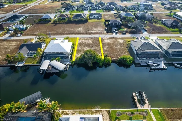 Aerial perspective of suburban area featuring a large body of water