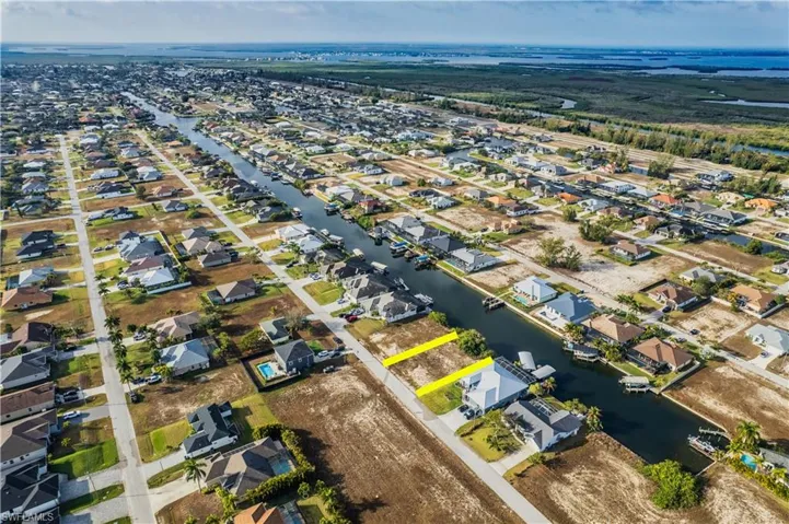 Aerial overview of property's location with nearby suburban area and a large body of water