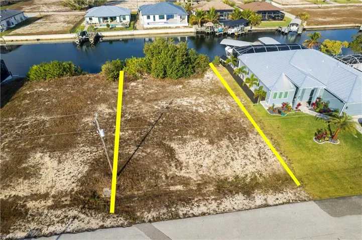 Aerial perspective of suburban area featuring a nearby body of water
