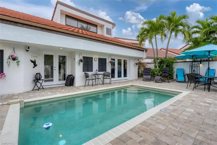 View of swimming pool featuring french doors and a patio