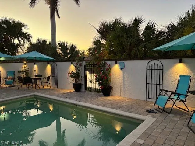 Pool at dusk with a patio area