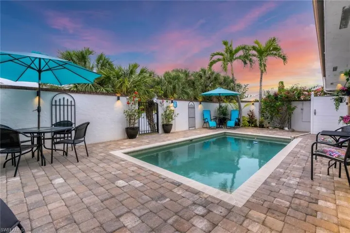Pool at dusk with a patio area