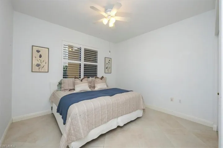 Bedroom featuring baseboards and ceiling fan
