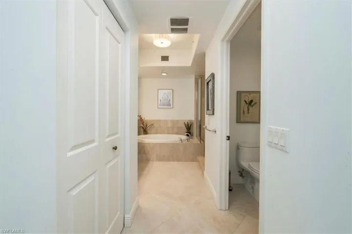 Full bath featuring a garden tub and light tile patterned floors