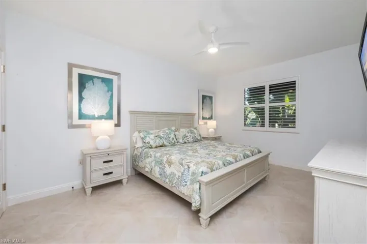 Bedroom with baseboards and a ceiling fan
