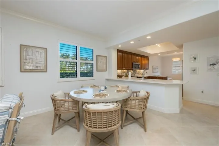 Dining space featuring recessed lighting and ornamental molding