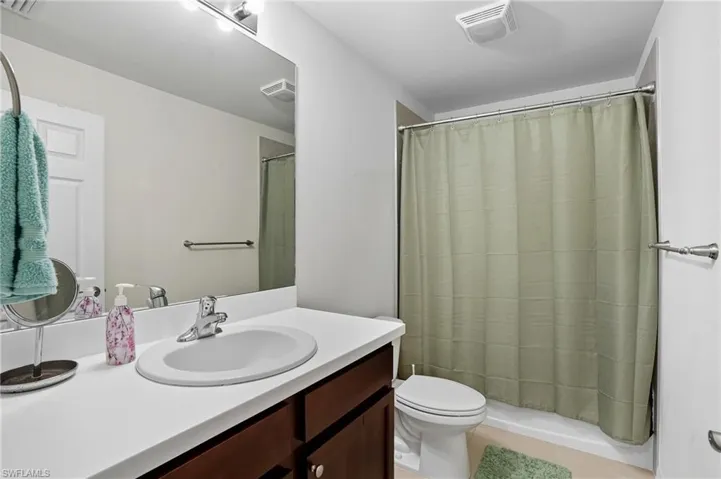 Bathroom with vanity, a shower stall, and light tile patterned floors