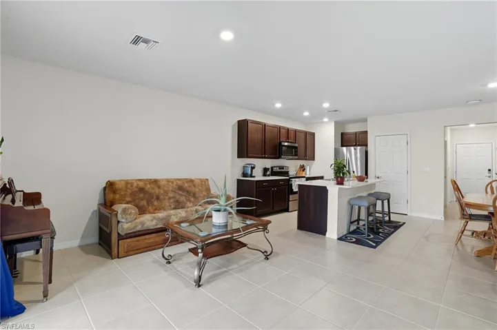 Living area featuring recessed lighting and light tile patterned floors