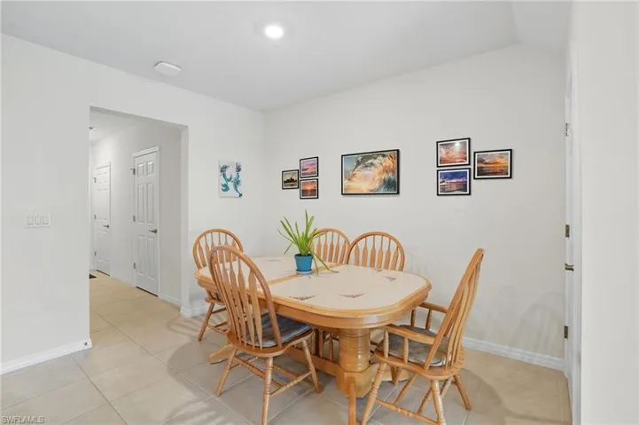 Dining room with light tile patterned floors and baseboards