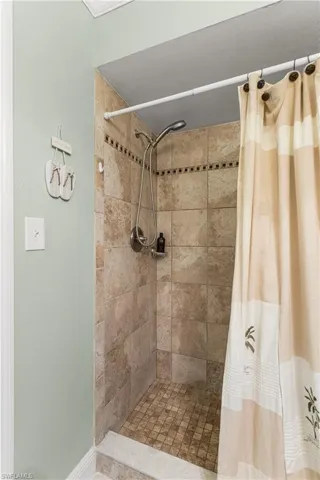 Bathroom featuring a shower with curtain