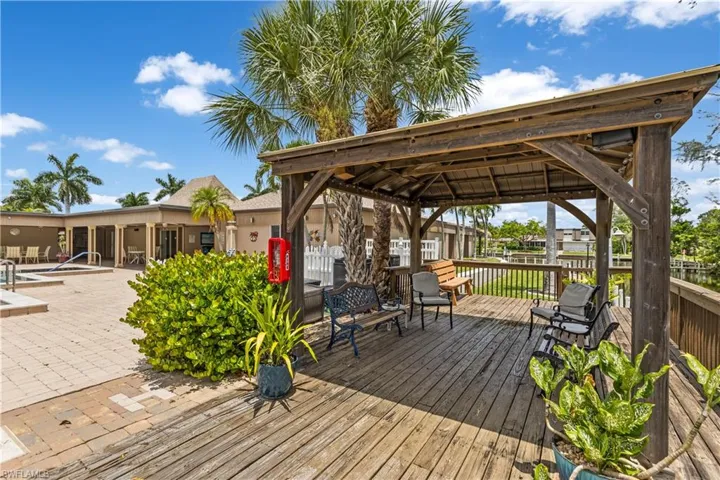 Wooden deck with a gazebo overlooking the pool and canal