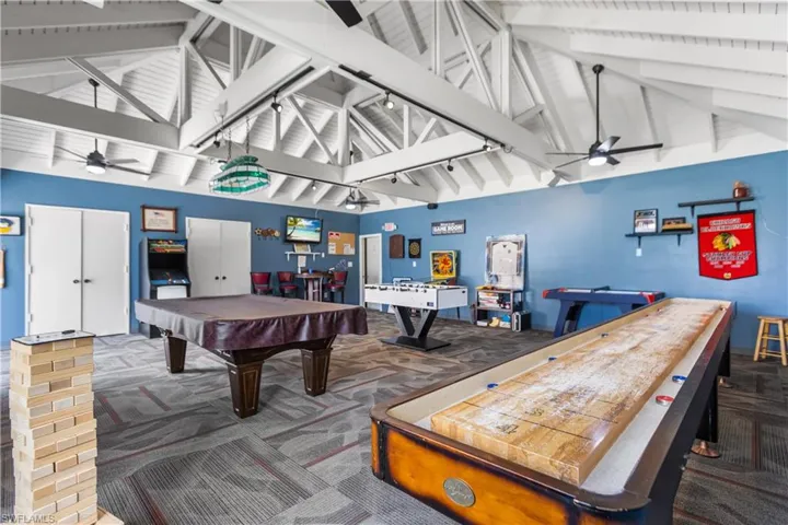 Rec room with beam ceiling, billiards, high vaulted ceiling, & carpet