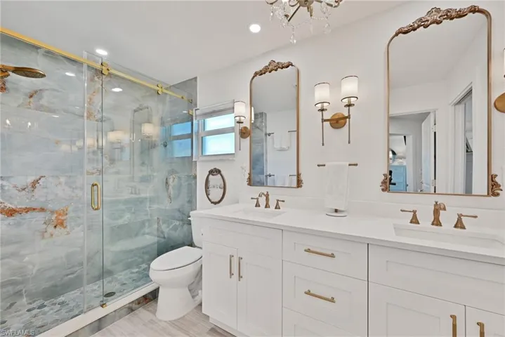 Bathroom featuring double vanity, toilet, a huge shower stall