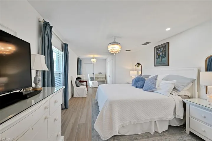 Second Primary Bedroom with recessed lighting, visible vents, a notable chandelier, and light wood-style flooring, private entrance to garage and to the side yard