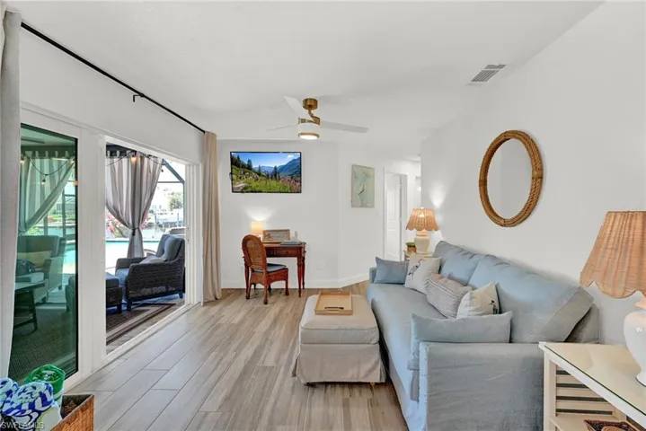 Den located between the great room and the guest bedrooms with sliders to the pool area